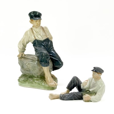 Lot 885 - A large Royal Copenhagen figure of a seated boy on rock holding a fishing rod.