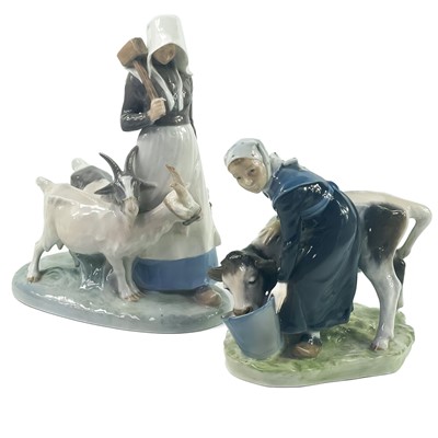 Lot 884 - A Royal Copenhagen figure of a cow and milkmaid.