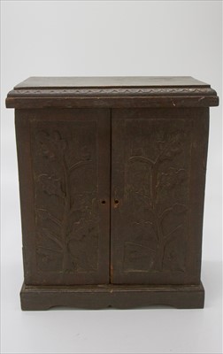 Lot 234 - An Arts and Crafts period oak table cabinet,...