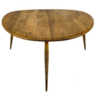 Lot 1951 - An Ercol elm pebble occasional table.