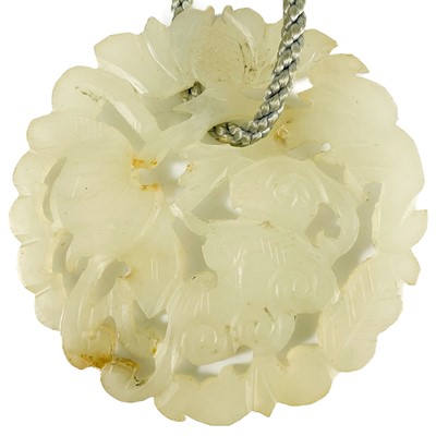 Lot 524 - A Chinese carved jade circular pendant.