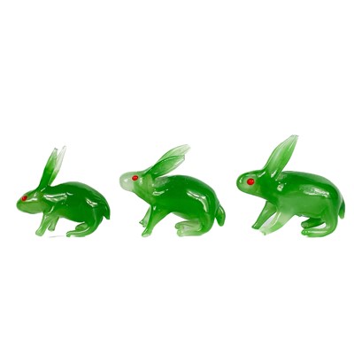 Lot 525 - Three Chinese graduated spinach jade models of rabbits.