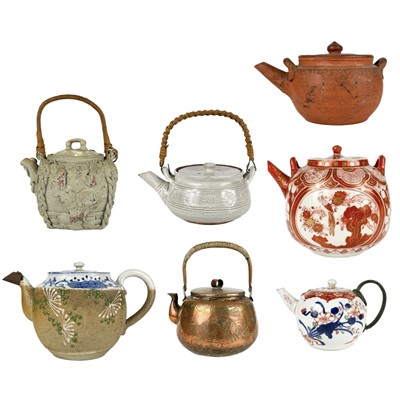 Lot 552 - A selection of seven Chinese and Japanese teapots.