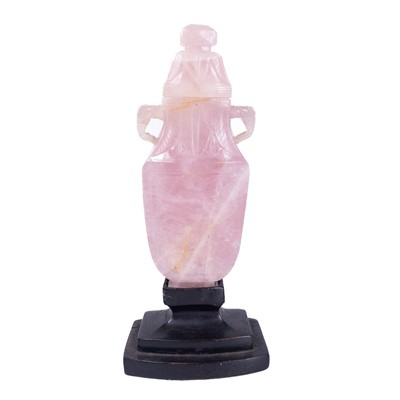 Lot 553 - A Chinese carved rose quartz vase, attached to a wooden stand.