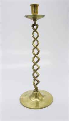 Lot 228 - A large brass candlestick with twisted stem.