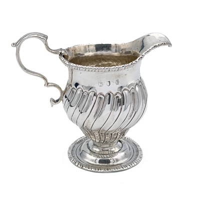 Lot 339 - An early George III silver wrythen fluted pedestal cream jug.