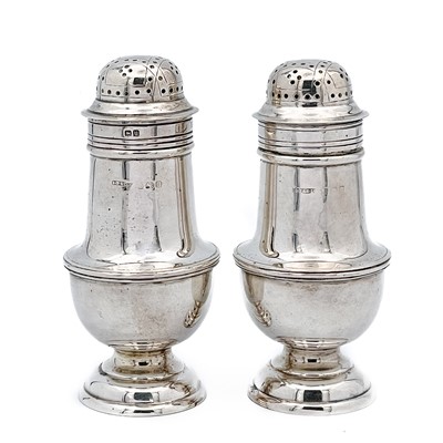 Lot 247 - A pair of George V silver pedestal pepper casters by S. Blanckensee & Son Ltd.