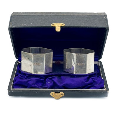 Lot 76 - A cased pair of silver napkin rings.