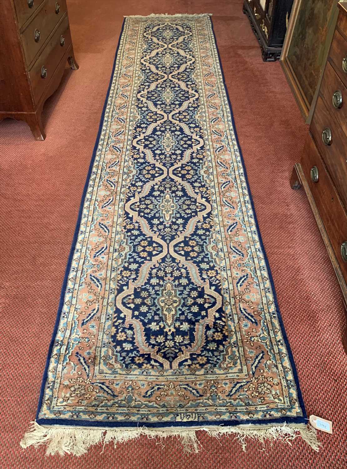 Lot 3162 - A Persian runner, the indigo field with six...