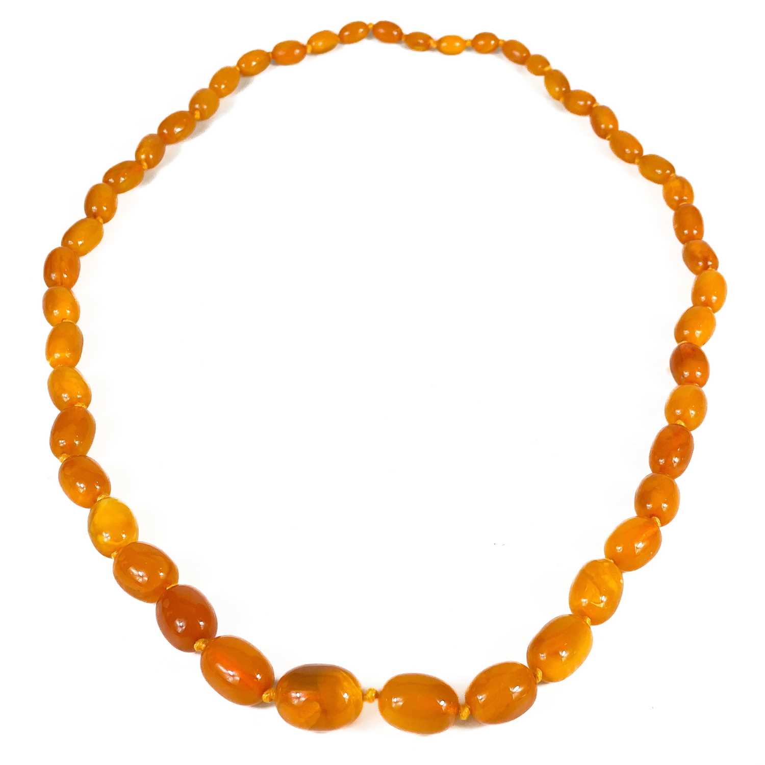 Lot 473 - A butterscotch amber oval graduated bead necklace.