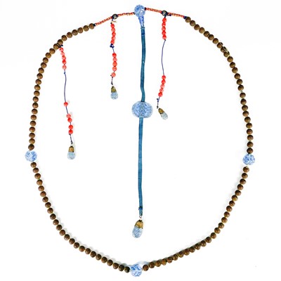 Lot 477 - A Chinese Qing dynasty Peking blue glass, carved nut and coral bead court necklace.