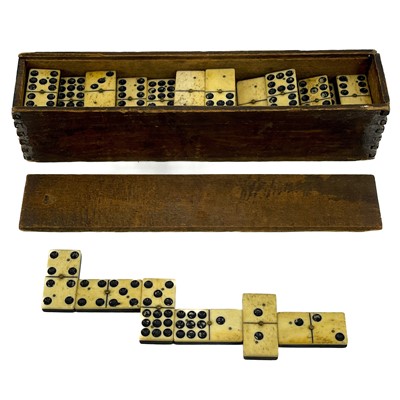 Lot 24 - A set of 19th century bone and ebony dominos.