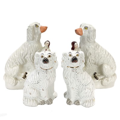 Lot 113 - A pair of Victorian Staffordshire figures of oversized spaniels.