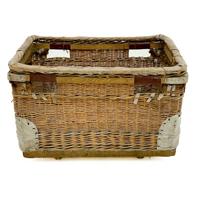 Lot 117 - A Large wicker basket with protective leather bumpers and edges.