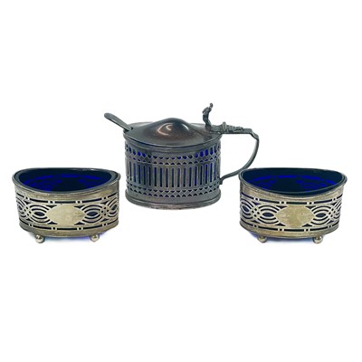 Lot 138 - A silver three piece cruet set with blue glass liners.