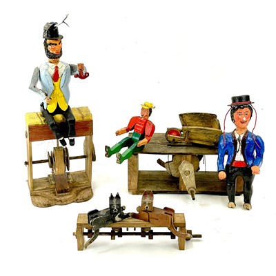 Lot 23 - An amusing painted wood automata of a gentleman on a hay bale.