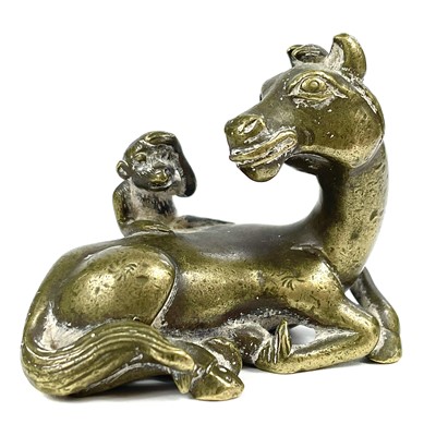 Lot 673 - A Chinese bronze scroll weight in the form of a horse, 19th century.