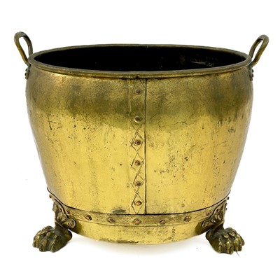 Lot 236 - A large brass coal bin with lion paw feet.