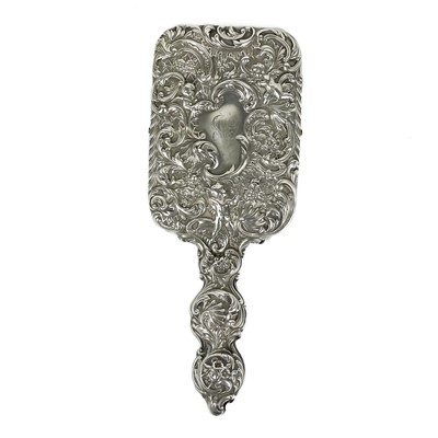 Lot 82 - A Victorian silver hand mirror by William Comyns.