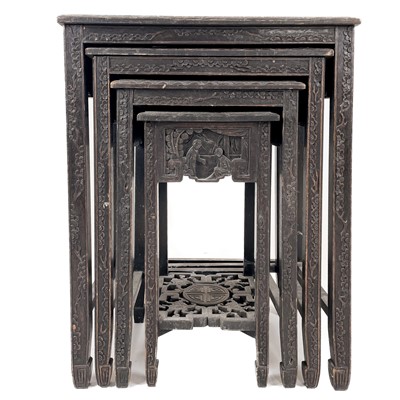 Lot 702 - A Chinese nest of four carved wood tables, early-mid 20th century.