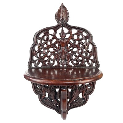 Lot 127 - An Indian teak folding wall bracket, early 20th century.