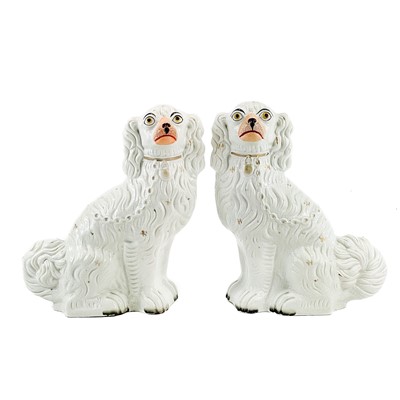 Lot 16 - A pair of Victorian Staffordshire figures of seated spaniels.