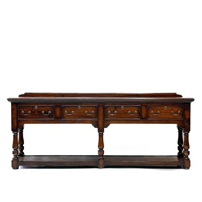 Lot 230 - A George III style oak low dresser.