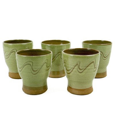 Lot 862 - Five studio pottery celadon yunomi cups with scraffito decoration.