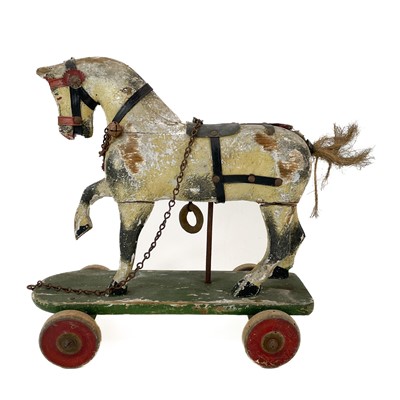 Lot 64 - A child's painted toy pull-along horse.