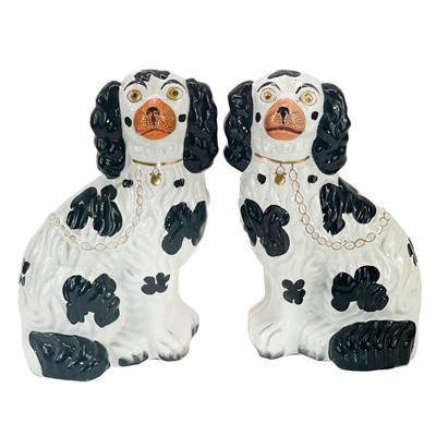 Lot 215 - A pair of Victorian Staffordshire pottery black and white figures of spaniels.