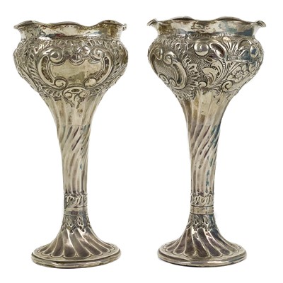 Lot 244 - A pair of Edwardian silver embossed trumpet vases by Miller Bros.