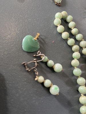 Lot 458 - A selection of green jade jewellery.