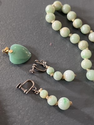 Lot 458 - A selection of green jade jewellery.