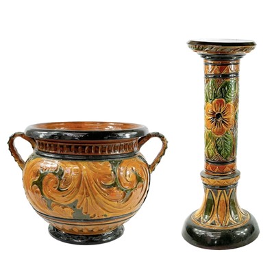 Lot 842 - A Majolica twin handled jardinere and stand.