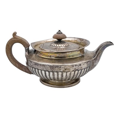 Lot 16 - A George IV silver half fluted pedestal teapot by Thomas Burwash.