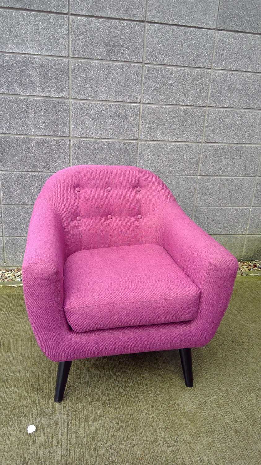 Lot 23 A modern upholstered purple tub chair with