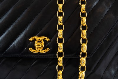 Lot 148 - A Chanel black lambskin leather chevron camera bag.