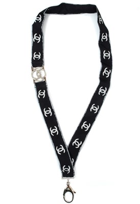 Lot 136 - A Chanel white tone metal and crystal set CC lanyard.