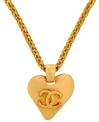 Lot 116 - A Chanel gold tone heart and CC pendant necklace.