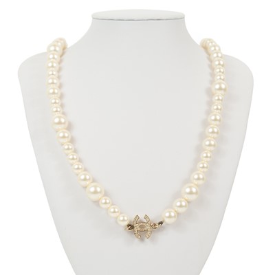 Lot 131 - A Chanel faux pearl and gold-tone CC crystal set necklace.