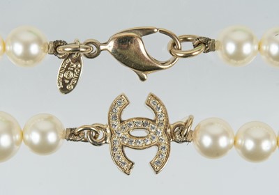 Lot 576 - A Chanel faux pearl and gold-tone CC crystal set necklace.