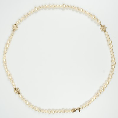 Lot 576 - A Chanel faux pearl and gold-tone CC crystal set necklace.