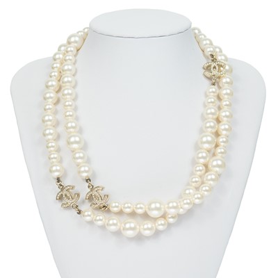 Lot 576 - A Chanel faux pearl and gold-tone CC crystal set necklace.