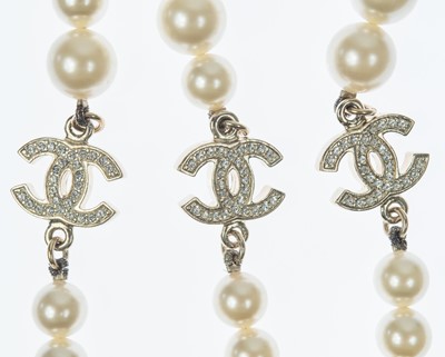 Lot 576 - A Chanel faux pearl and gold-tone CC crystal set necklace.
