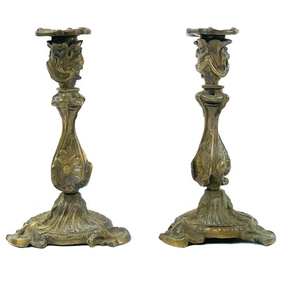 Lot 30 - A pair of French rococo brass candlesticks.