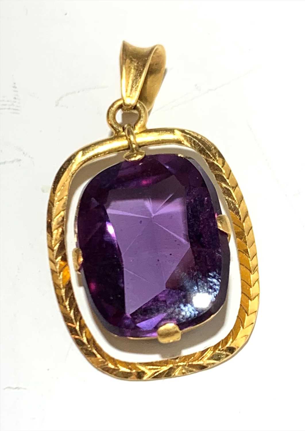 Lot 2567 - A 22ct gold amethyst set pendant.