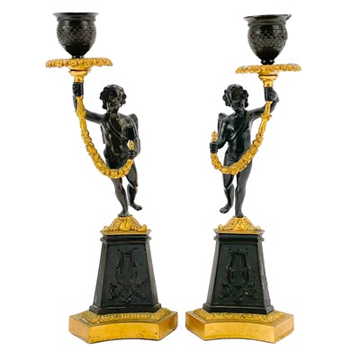 Lot 16 - A pair of Regency style bronze and ormolu candlesticks.