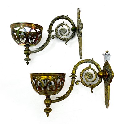 Lot 185 - A pair of Victorian wall bracket brass oil lamps with cranberry glass shades.