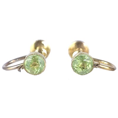 Lot 70 - A pair of early 20th century high purity gold (tests 14ct) peridot set screw back earrings.