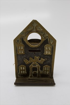 Lot 350 - A brass and painted steel money bank, late...